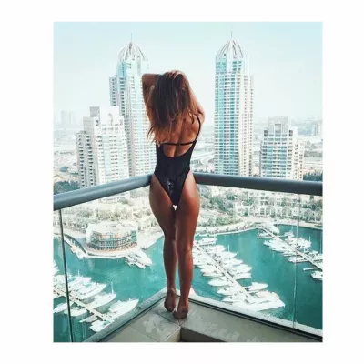 One piece swimwear in Dubai: where to buy and what to wear? : Woman wearing a one piece swimwear above Dubai marina