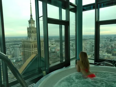 How To Choose A Swimsuit For Winter? Ski, jacuzzi, swimming pool : Beautiful young woman wearing a plain orange bikini in the jacuzzi in winter in Warsaw Intercontinental high rise spa